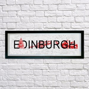 May include: A black framed print with a white background and red text that reads "EDINBURGH". The text is made up of images of the city's landmarks, including the Forth Bridge and Edinburgh Castle.