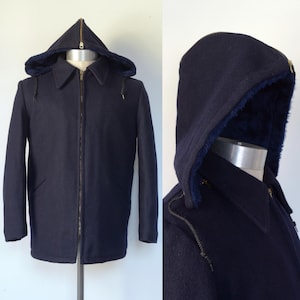 May include: A navy blue hooded jacket with a zipper closure. The jacket has a lined hood and a fleece lining.