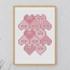 May include: A framed cross-stitch design featuring a pattern of interlocking hearts in shades of pink and red. The hearts are arranged in a symmetrical pattern, creating a visually appealing and intricate design.