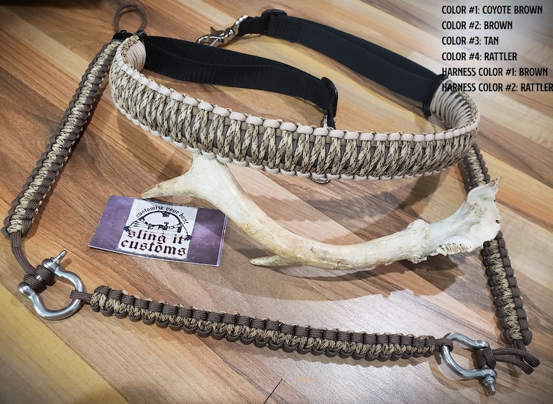 May include: A selection of hunting accessories, including a rifle sling and a harness, in shades of brown and tan. The items are made with braided cord and metal fixings. A deer antler and a business card with the text "Bling it Customs" are also visible.