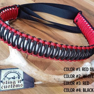 May include: Red, white, and black paracord sling with a diamond pattern. The sling is made by Sling It Customs and is customizable. The text "customize your hunt" and "sling it customs" is on a white card.