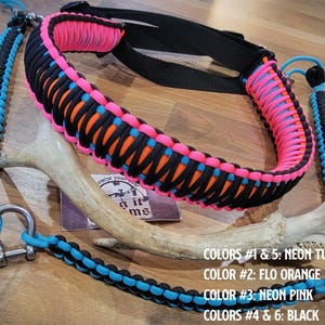 May include: A brightly coloured rifle sling made from paracord in neon turquoise, flo orange, neon pink, and black. The sling has a black strap and metal fixings. The image text reads: COLORS #1 & 5: NEON TURQUOISE, COLOR #2: FLO ORANGE, COLOR #3: NEON PINK, COLORS #4 & 6: BLACK.