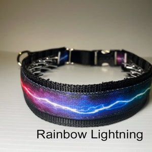 May include: A black dog collar featuring a rainbow lightning bolt design. The collar has a metal buckle and is adjustable.