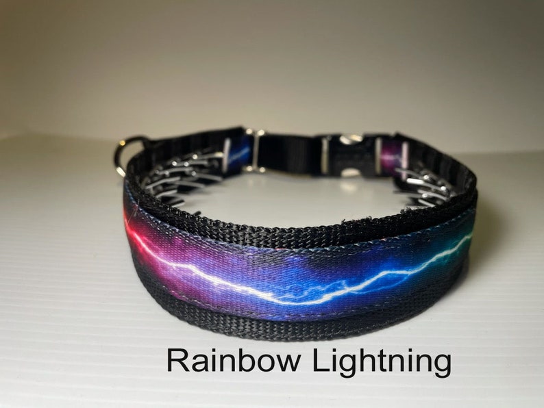 May include: A black dog collar featuring a rainbow lightning bolt design. The collar has a metal buckle and is adjustable.