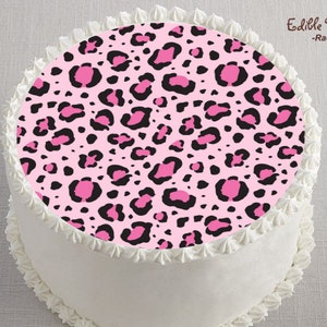 May include: A white cake with a pink and black leopard print edible image on top. The image says "Edible Perfections - Rachana Cherry".