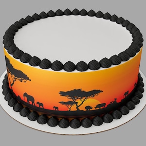 May include: A round cake with black frosting and a printed edible image of an African sunset with silhouettes of trees, elephants, and a rhinoceros.