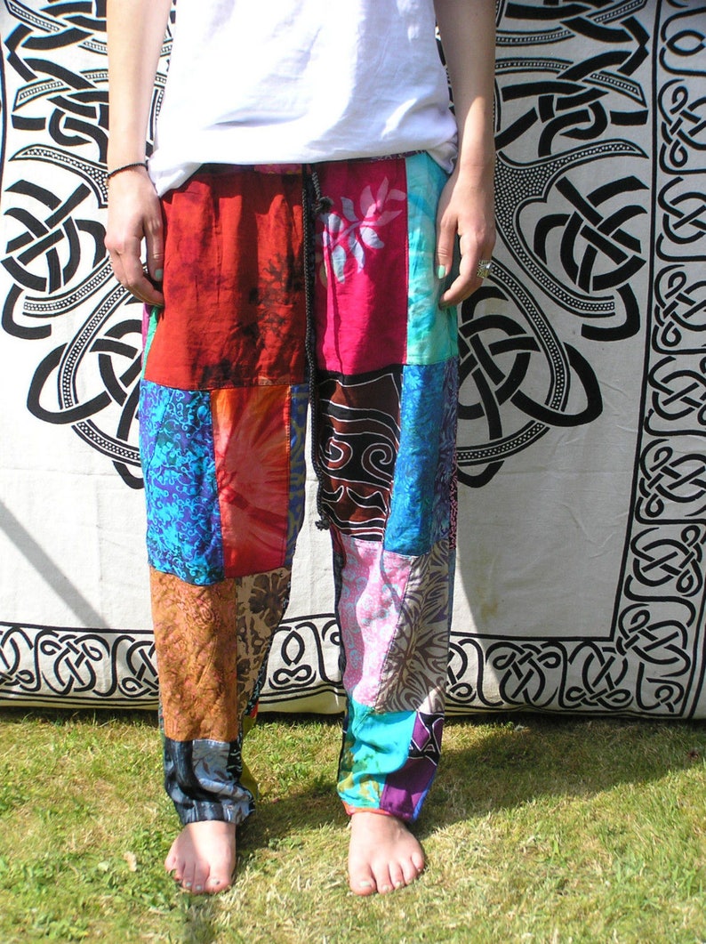 May include: Patchwork pants with a variety of colors and patterns, including red, blue, pink, and brown. The pants are made of different fabrics and have a drawstring waist.