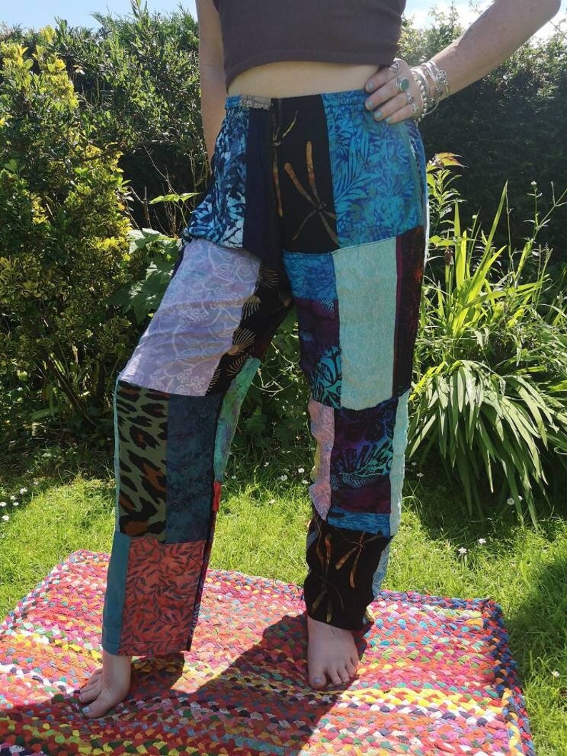May include: Patchwork pants with a variety of colors and patterns, including blue, green, pink, and black. The pants have a wide leg and a relaxed fit.