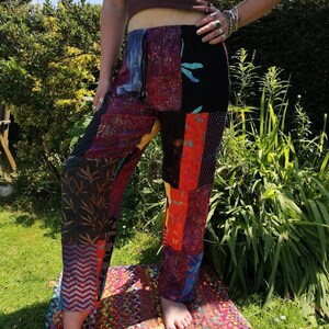 May include: Patchwork pants with a variety of colors and patterns, including black, red, orange, yellow, blue, and green. The pants have a drawstring waist and a relaxed fit.