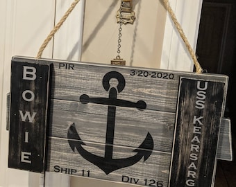 May include: A wooden sign with a black anchor and the text "USS KEARSARGE", "BOWIE", "PIR", "SHIP 11", "DIV 126", and "3-20-2020".