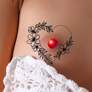 Könnte beinhalten: Zwei schwarze Blumenherz-Tattoos mit roten Punkten in der Mitte.