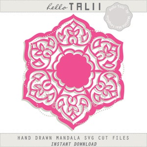 May include: A layered, pink and white mandala design with intricate floral and geometric patterns. The design features the text "hello TALII" at the top and "HAND DRAWN MANDALA SVG CUT FILES INSTANT DOWNLOAD" at the bottom. A circular logo with text is in the upper right corner.