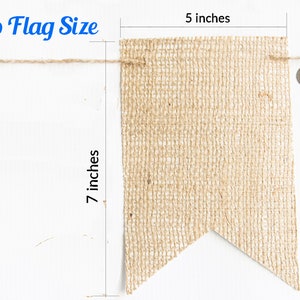 May include: A burlap flag measuring 7 inches tall and 5 inches wide. The flag is made of natural burlap fabric and has a pointed bottom edge. The flag is shown next to a US quarter for size reference.