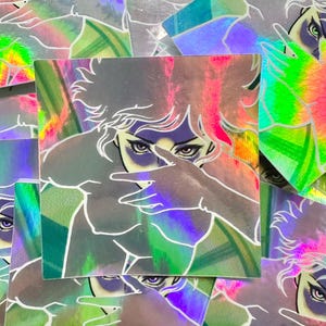 May include: Holographic stickers featuring a stylized illustration of a person with a hand covering their face. The stickers have a rainbow sheen with pink, green, and purple hues. The illustration is outlined in white.