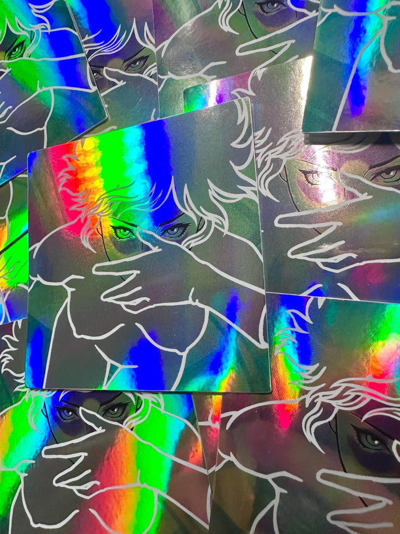 May include: Holographic stickers featuring a stylized illustration of a person with hands covering their face. The artwork is outlined in white against a background that reflects a rainbow of colors. The stickers have a square shape.