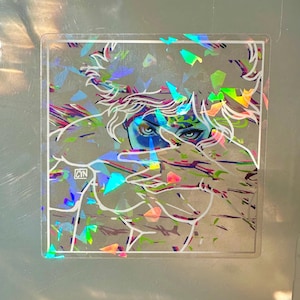 May include: Holographic sticker featuring a stylized illustration of a person with blue eyes and white hair. The artwork is overlaid with iridescent, geometric shapes. The sticker has a clear border and the initials "CYN" are visible.