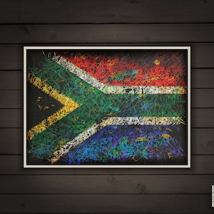 May include: Framed artwork featuring the South African flag, rendered with colorful, scribbled lines on a black background. The flag's design includes red, white, blue, yellow, and green elements, set within a white border.