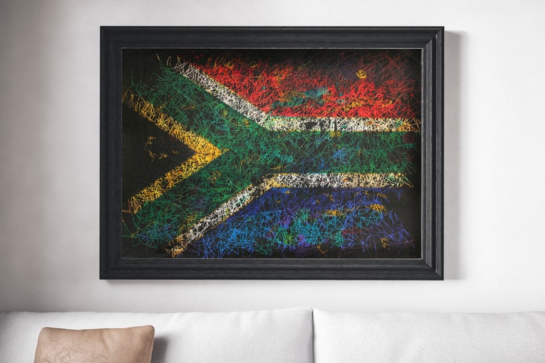 May include: A framed artwork featuring the South African flag, rendered with colorful, scribbled lines on a black background. The flag's design includes red, white, blue, green, and yellow elements. The frame is black.