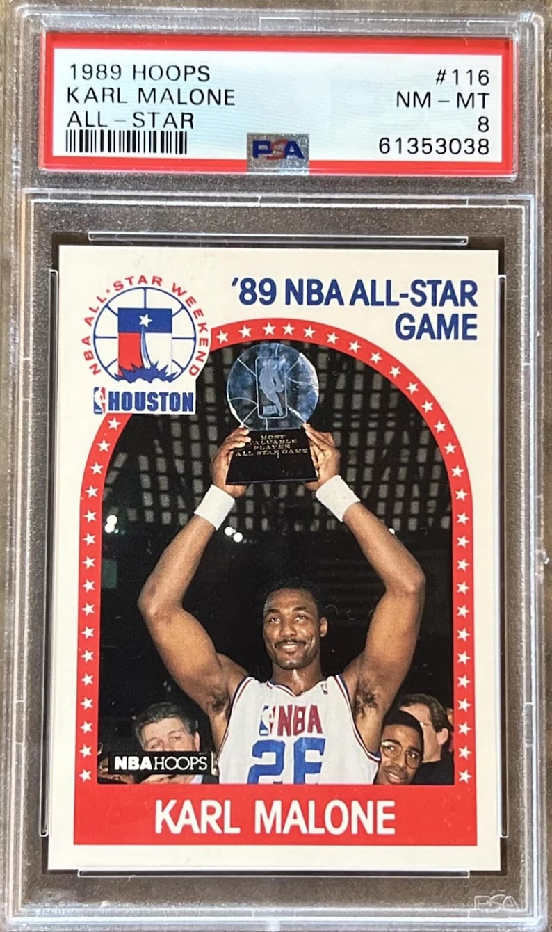 Pu&ograve; includere: Una carta da collezione NBA Hoops del 1989 con Karl Malone, giocatore degli Utah Jazz, che tiene in alto il trofeo di Most Valuable Player del NBA All-Star Game del 1989 a Houston, Texas. La carta &egrave; in condizioni quasi perfette.