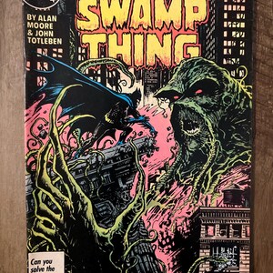 Könnte beinhalten: Ein Vintage-Comic-Cover für "Swamp Thing" mit Batman, einer monströsen Figur und Stadtlandschaften. Das Cover trägt den Text "Giant-Sized Spectacular!" und "Can you solve the DC CHALLENGE before we do?" Der Comic ist Ausgabe Nr. 53.