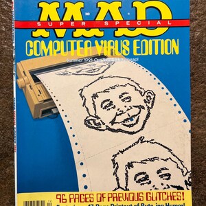 May include: A Mad Super Special Computer Virus Edition magazine from Summer 1991. The cover features a tan dot matrix printer feeding a continuous sheet of paper with black and white pixelated illustrations of Alfred E. Neuman's face.