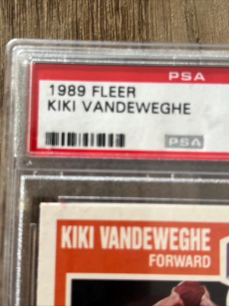 May include: A 1989 Fleer Kiki Vandeweghe trading card, encased in a protective PSA holder. The card features the player's name and the word "FORWARD". The PSA label is red and white.