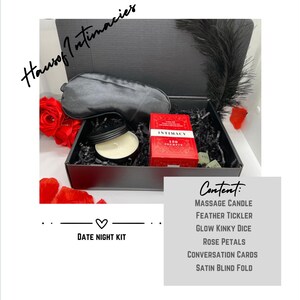 May include: A black date night kit with a satin blindfold, massage candle, feather tickler, glow in the dark dice, rose petals, and conversation cards. The kit includes a box of "Intimacy" cards. The text "Date Night Kit" is also visible.