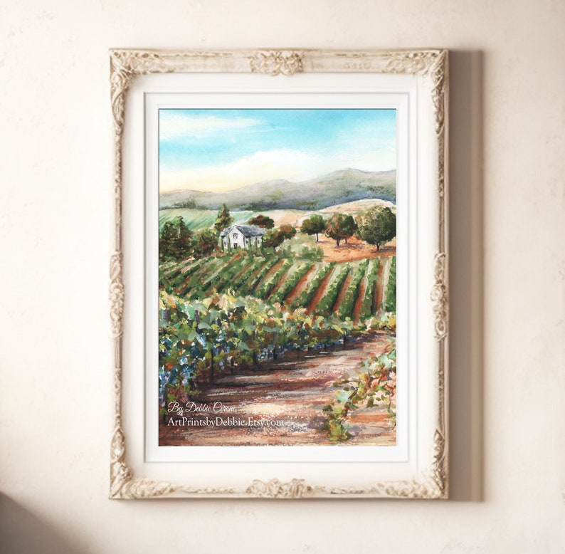 May include: A watercolor painting of a vineyard with a small white house in the distance. The vineyard is surrounded by rolling hills and a blue sky with white clouds. The painting is signed "By Debbie Green" and "ArtPrintsbyDebbieEtsy.com".