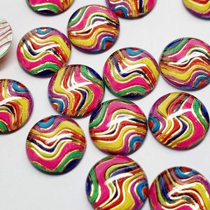 May include: A collection of colorful, round cabochons with a swirling pattern. The cabochons feature a vibrant mix of pink, yellow, green, blue, and gold, creating a dynamic and eye-catching design. These decorative elements are ideal for jewelry making.