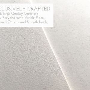 May include: Close-up of a white textured cardstock. The text "EXCLUSIVELY CRAFTED" is printed at the top of the cardstock. The text below reads: "&bull;Thick High Quality Cardstock &bull;100% Recycled with Visible Fibers &bull;Textured Outside and Smooth Inside"