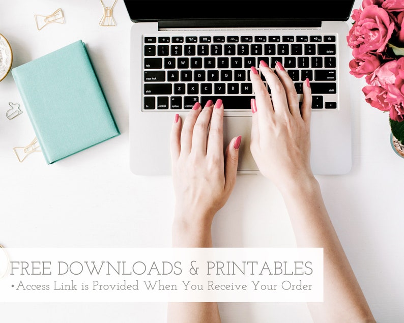 Pu&ograve; includere: Le mani di una persona che digita su un computer portatile argentato con una tastiera bianca. Il computer portatile &egrave; su una superficie bianca con un quaderno blu, graffette dorate e fiori rosa sullo sfondo. Il testo "FREE DOWNLOADS & PRINTABLES" &egrave; nella parte inferiore dell'immagine.