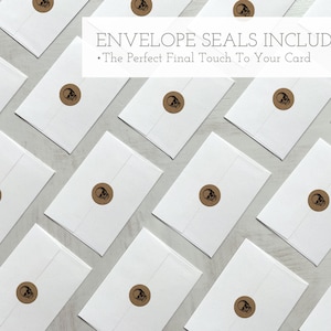 May include: A flat lay of white envelopes with brown skull seal stickers. The text "Envelope Seals Included" and "The Perfect Final Touch To Your Card" is displayed above the envelopes.