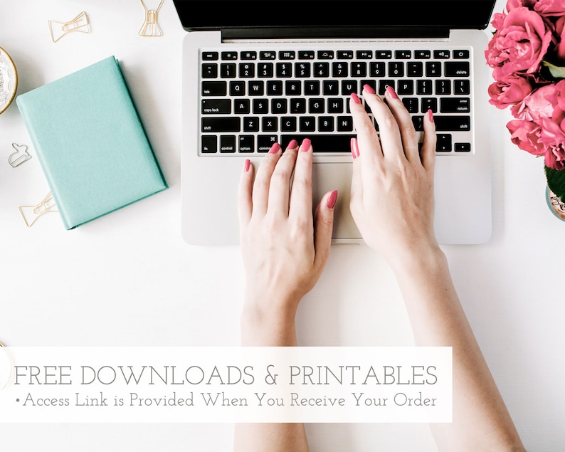 May include: A person's hands typing on a silver laptop computer with a white keyboard. The laptop is on a white surface with a blue notebook, gold paper clips, and pink flowers in the background. The text "FREE DOWNLOADS & PRINTABLES" is at the bottom of the image.