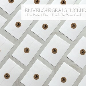 May include: A flat lay of white envelopes with brown skull seal stickers. The text "Envelope Seals Included" and "The Perfect Final Touch To Your Card" is displayed above the envelopes.