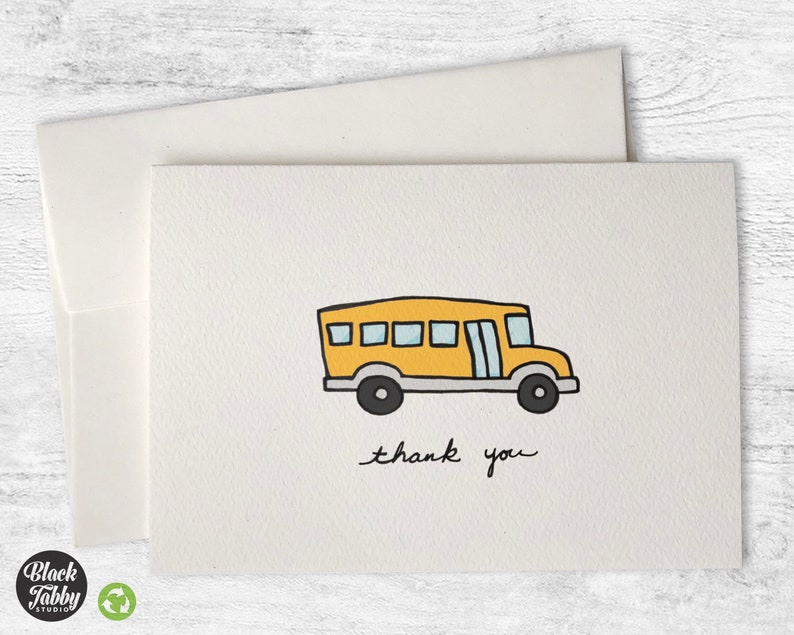 May include: A yellow school bus with a thank you message. The bus has a black outline and black wheels. The message is written in black ink.