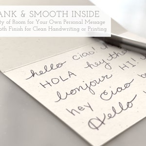 May include: A blank card with a smooth finish, perfect for writing or printing personal messages. The card features the text "BLANK & SMOOTH INSIDE" and "Plenty of Room for Your Own Personal Message" and "Smooth Finish for Clean Handwriting or Printing". The card also features handwritten greetings in various languages, including "hello", "ciao", "hola", "bonjour", and "HI!"