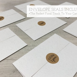 May include: Five white envelopes with brown paper thank you and thanks seals. The text "ENVELOPE SEALS INCLUDED" and "The Perfect Final Touch To Your Card" is at the top of the image.
