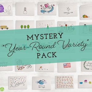 May include: A set of 20 blank greeting cards with various illustrations, including a school bus, a Christmas tree, a watermelon, a birthday cake, a unicorn, a fish, a rainbow, and a heart. The cards are arranged in a grid on a white wooden background. The text "MYSTERY "Year-Round Variety" PACK" is written in a teal banner across the middle of the image.