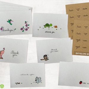 May include: Set of eight thank you cards with various illustrations, including a hummingbird, a turtle, a pig, an owl, and a squirrel. The cards are printed on recycled paper and have a rustic look. The set also includes a sheet of 12 round thank you stickers.