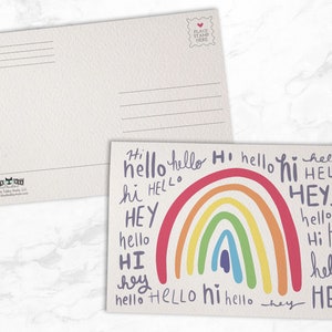 May include: A postcard with a rainbow and the words "hi", "hello", and "hey" written in different colors and styles.