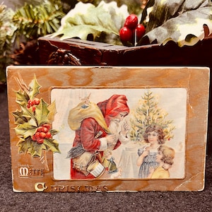 Victoriaanse kerstbriefkaart uit het begin van de 20e eeuw met een kaarsverlichte boom