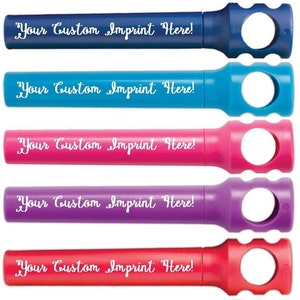 May include: Seven colorful bottle stoppers with a hole in the top and the text "Your Custom Imprint Here!" in white lettering.