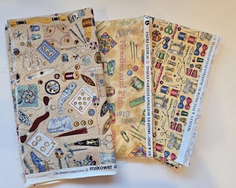 May include: Three fabric panels with sewing-themed patterns. One features sewing tools like scissors, needles, and spools on a beige background. Another has text that reads "Hunter's Nine Needles and Pins". The third has sewing machines and other tools.