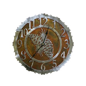 May include: A rustic metal clock with a pine cone design and Roman numeral markings. The clock face is a rusty brown color with a silver metal frame.
