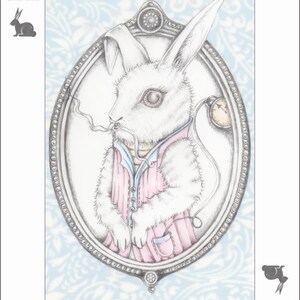 May include: A white rabbit wearing a pink shirt and a pocket watch, in a silver oval frame with a blue and white patterned background. The text "Three on the Treetop" is below the frame.