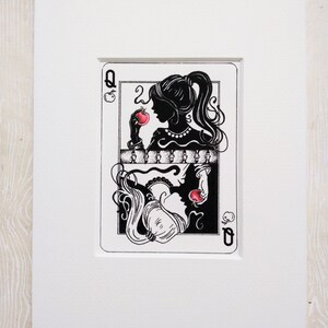 May include: Black and white illustration of a queen of hearts playing card with a woman holding an apple in her hand. The card has a black background with white outlines and the queen is wearing a crown and a necklace.