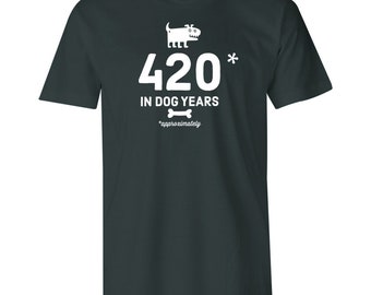 May include: A dark green t-shirt with a white graphic of a dog and the text "420* in dog years *approximately".