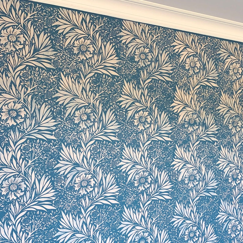 May include: A blue wallpaper with a white floral pattern. The pattern features stylized leaves and flowers.