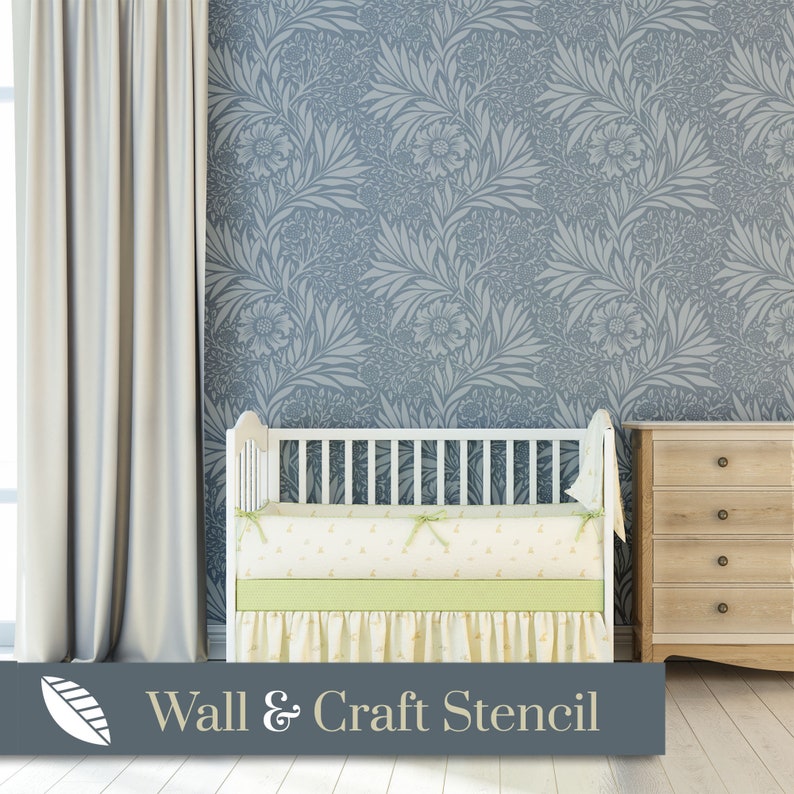 May include: A white crib with a light green and white patterned bedding set in front of a blue wall with a floral stencil pattern. The text "Wall & Craft Stencil" is at the bottom of the image.