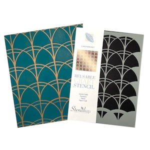 May include: Reusable craft stencil with a geometric pattern of overlapping arches. The stencil is black and is shown on a gray background. The stencil is labeled "Reusable Craft Stencil" and "StenciLup Creative Stencils".